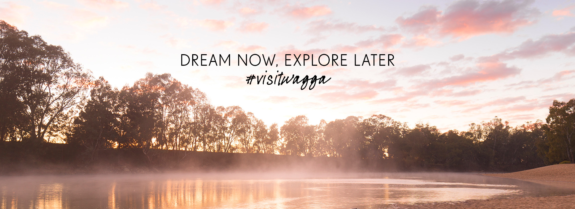 Riverside: Wagga Beach on a winters morning with the sun rising and mist over the water