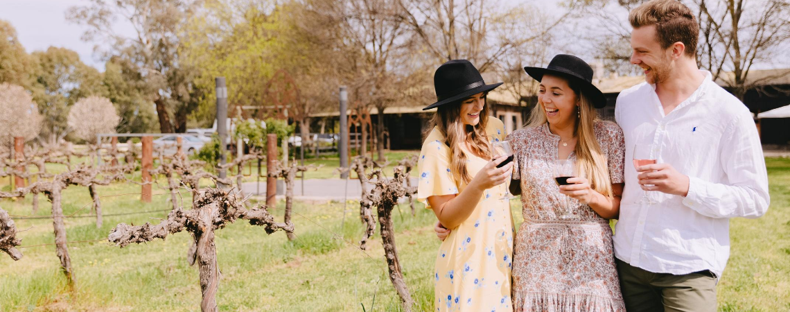 Three friends enjoying wine at a Wagga Wagga vineyard