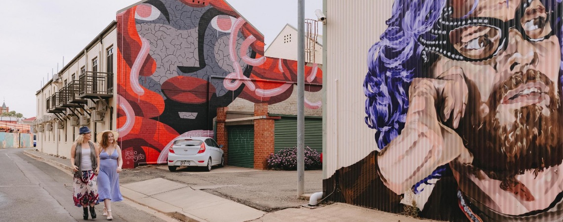 Two females admiring the laneway street art murals in Wagga Wagga 